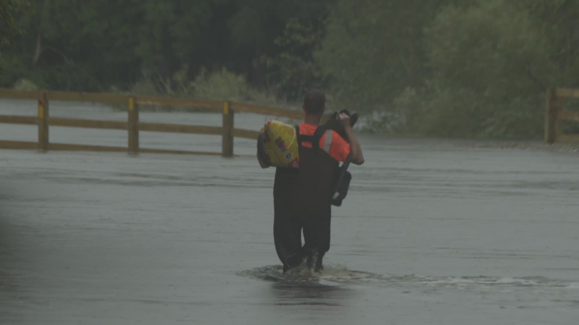 Neighbors waded through floodwaters Tuesday afternoon after Debby blew through. Some navigated by boat.