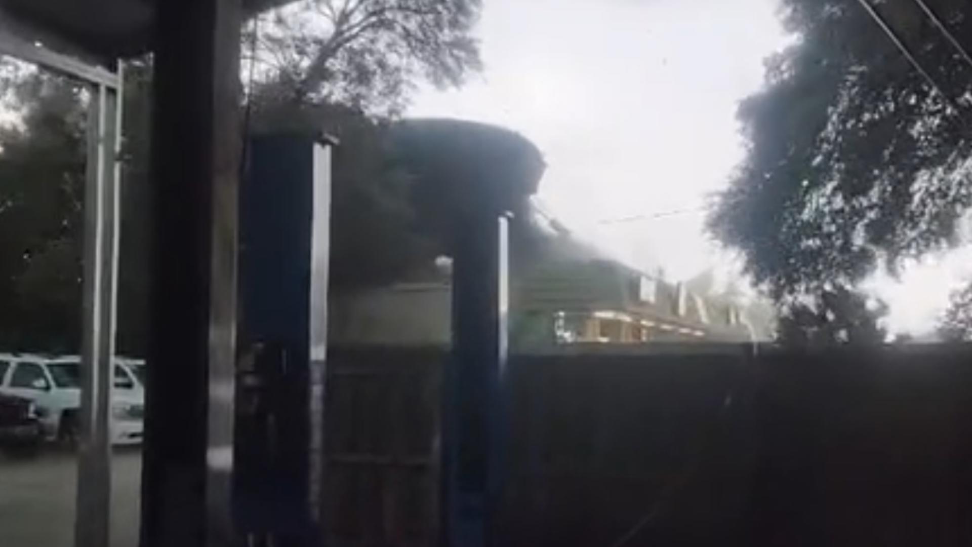 Onlookers film a roof being ripped off a Jacksonville business.