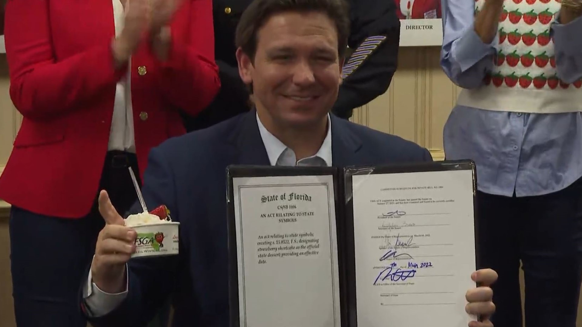 The governor took a bite of the sweet treat and gave it a thumbs up before signing the bill.